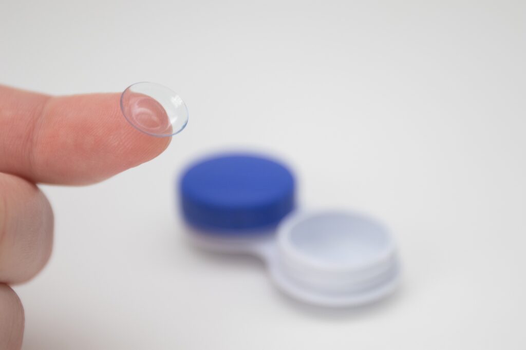 Hand holding Contact Eye Lenses.